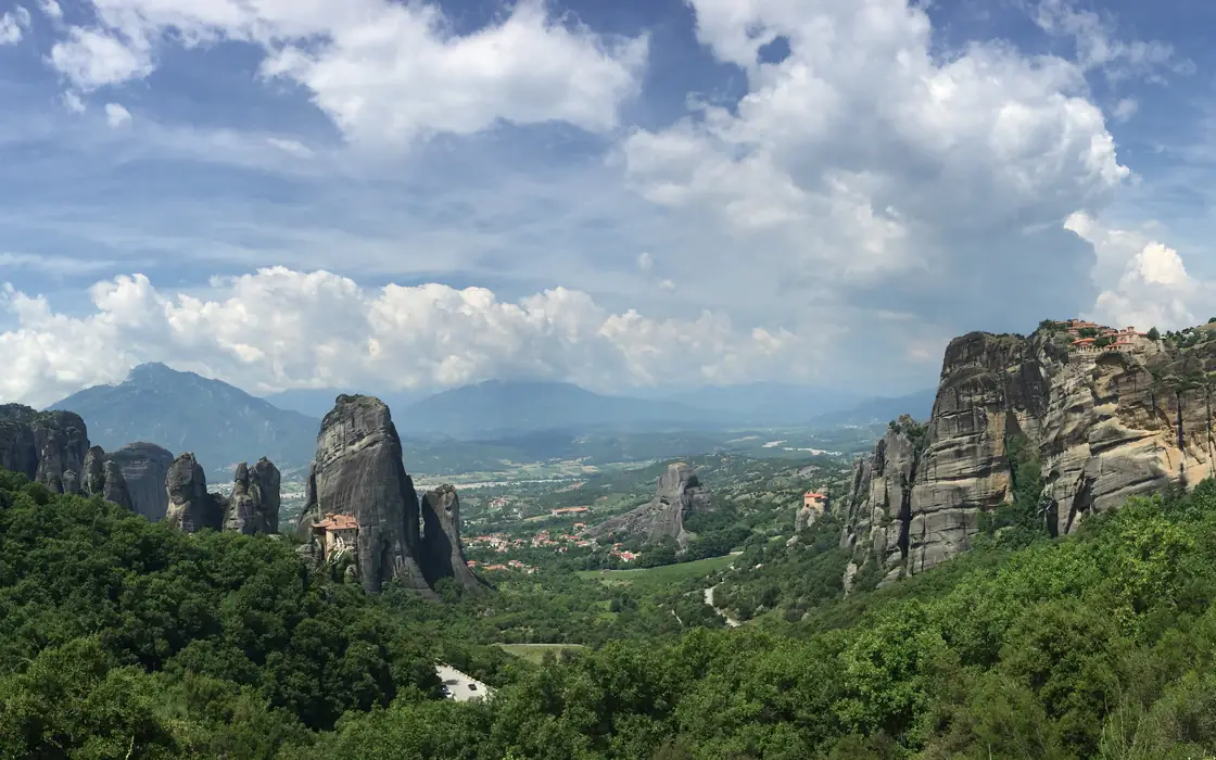 Meteora rock formations and monasteries above a green valley